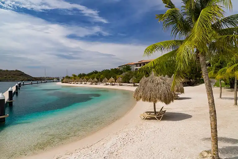 Sandy beach and turquoise water at Sandals Royal Curacao