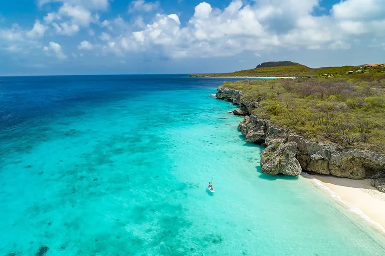 Aerial view of paddleboarders at Cas Abao Beach near Sandals Royal Curacao