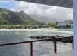 View of the beach and mountains from an overwater pergola at Sandals St. Vincent