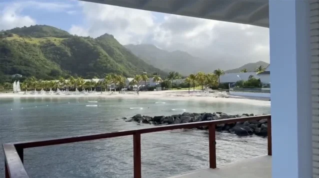 View of the beach and mountains from an overwater pergola at Sandals St. Vincent