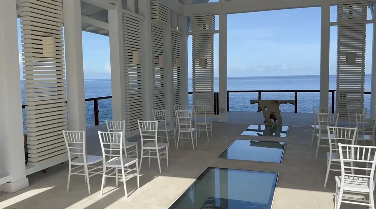 Oceanview wedding chapel with white chairs set up for a Sandals destination wedding ceremony