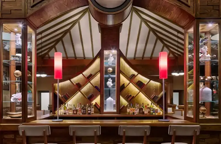 Wood-paneled restaurant bar interior with pagoda-style ceiling at Sandals Barbados