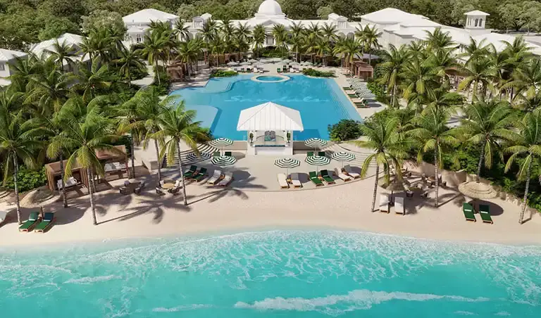 Beachfront pool with cabanas and loungers at Sandals South Coast