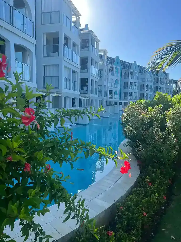 Courtyard pool with flowering plants at Sandals South Coast