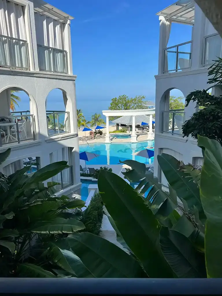 Courtyard pool view with balconies at Sandals South Coast