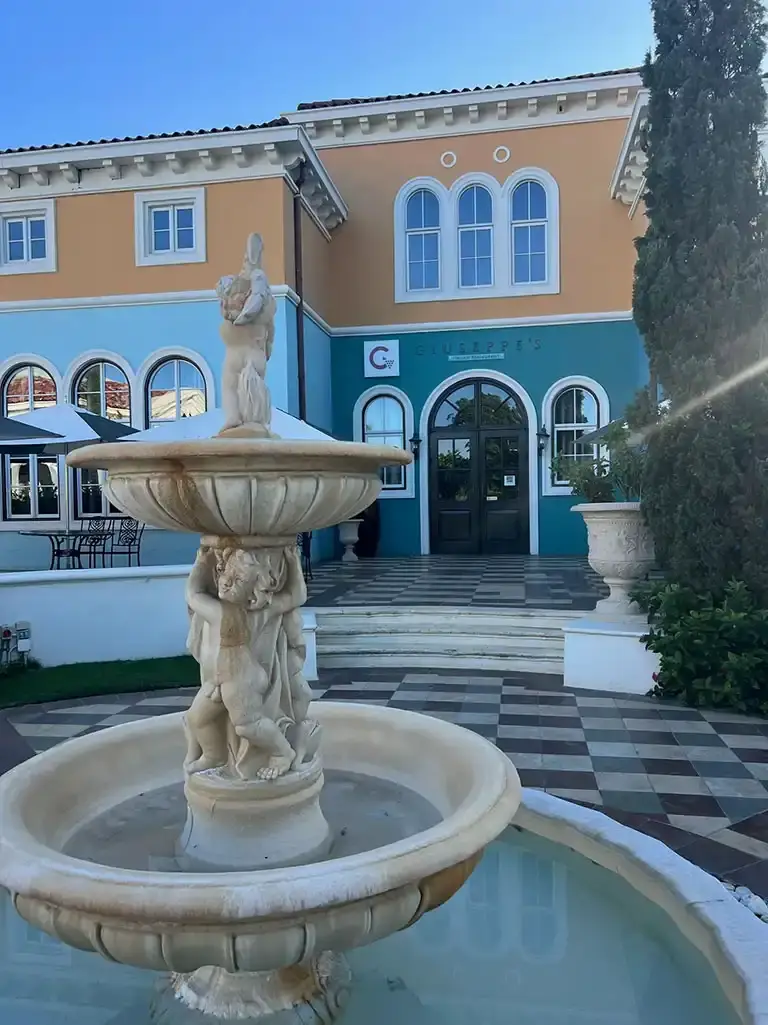 Mediterranean-style building with fountain at Sandals South Coast
