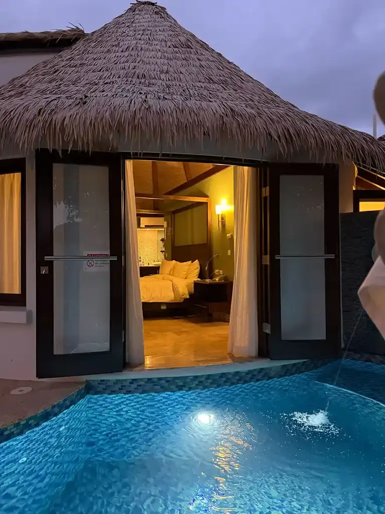 Overwater bungalow suite with pool at dusk at Sandals South Coast