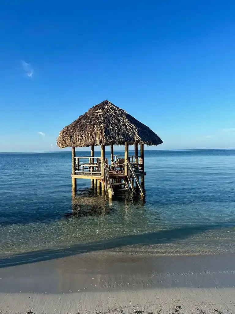Overwater thatched hut on the beach at Sandals South Coast