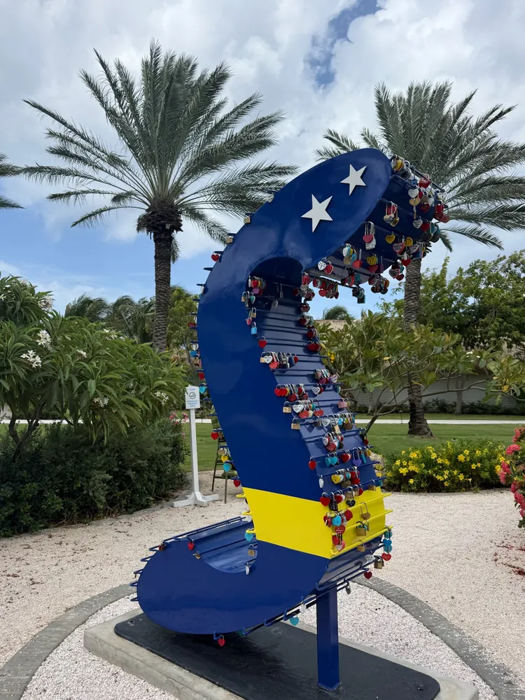 Heart locks on the blue and yellow Curaçao display at Sandals Royal Curaçao
