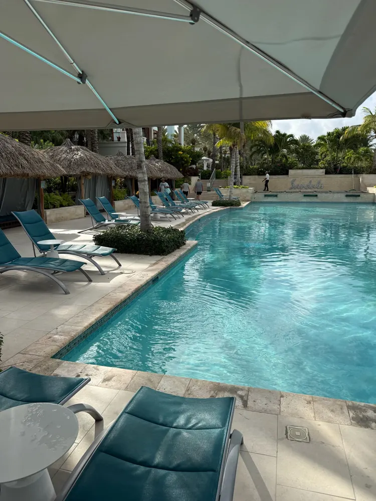 Activities pool with umbrellas and loungers at Sandals Royal Curaçao