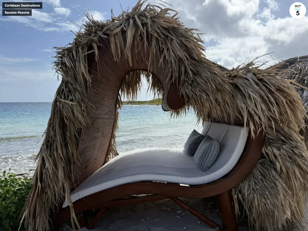 Heart-shaped thatched beach lounger facing the water at Sandals Royal Curaçao